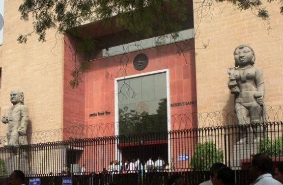 Yaksha and Yakshi statues standing at the entrance of the Reserve Bank of India offices in India.